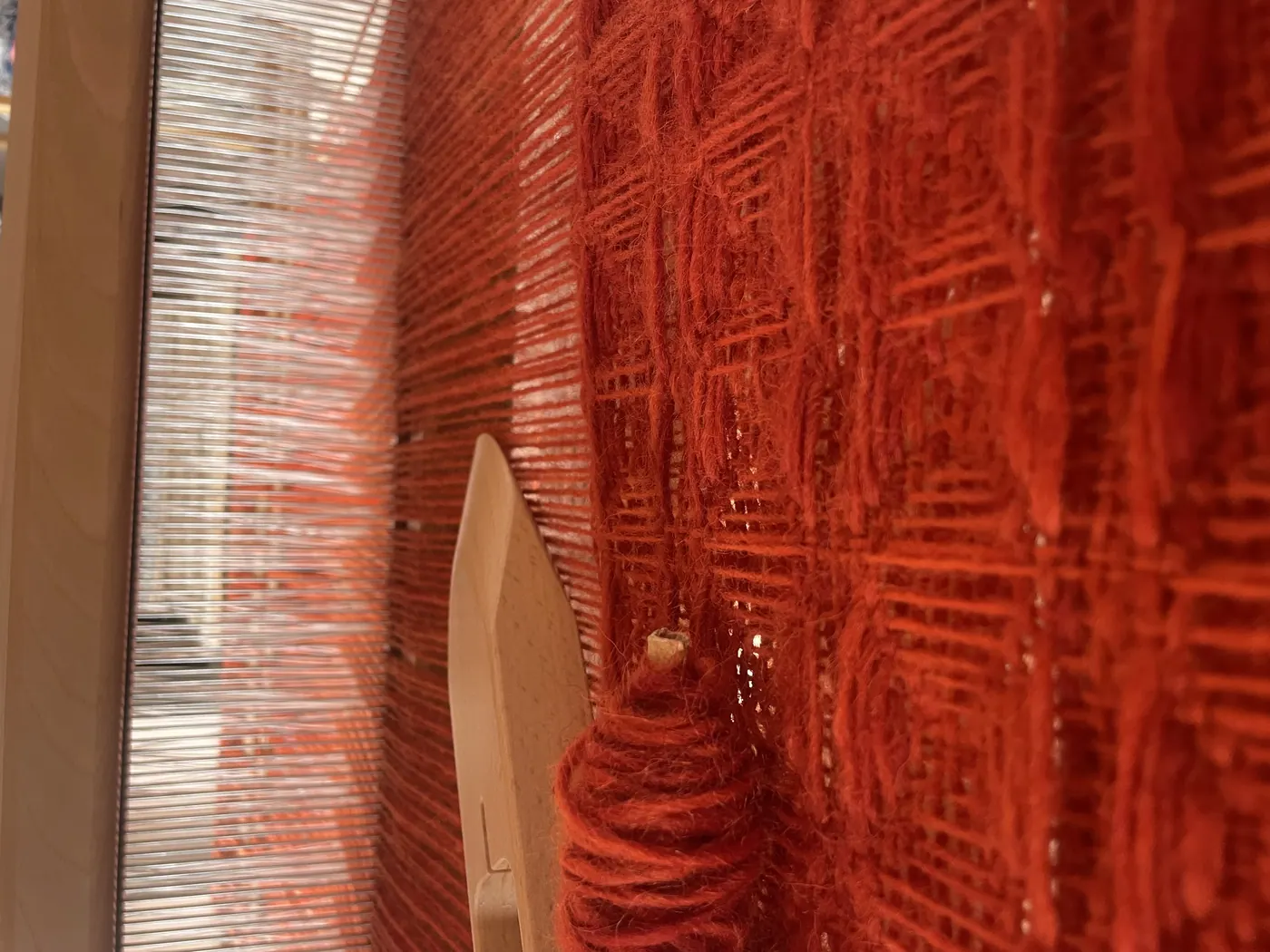 Aviva Leigh weaving with a loom
